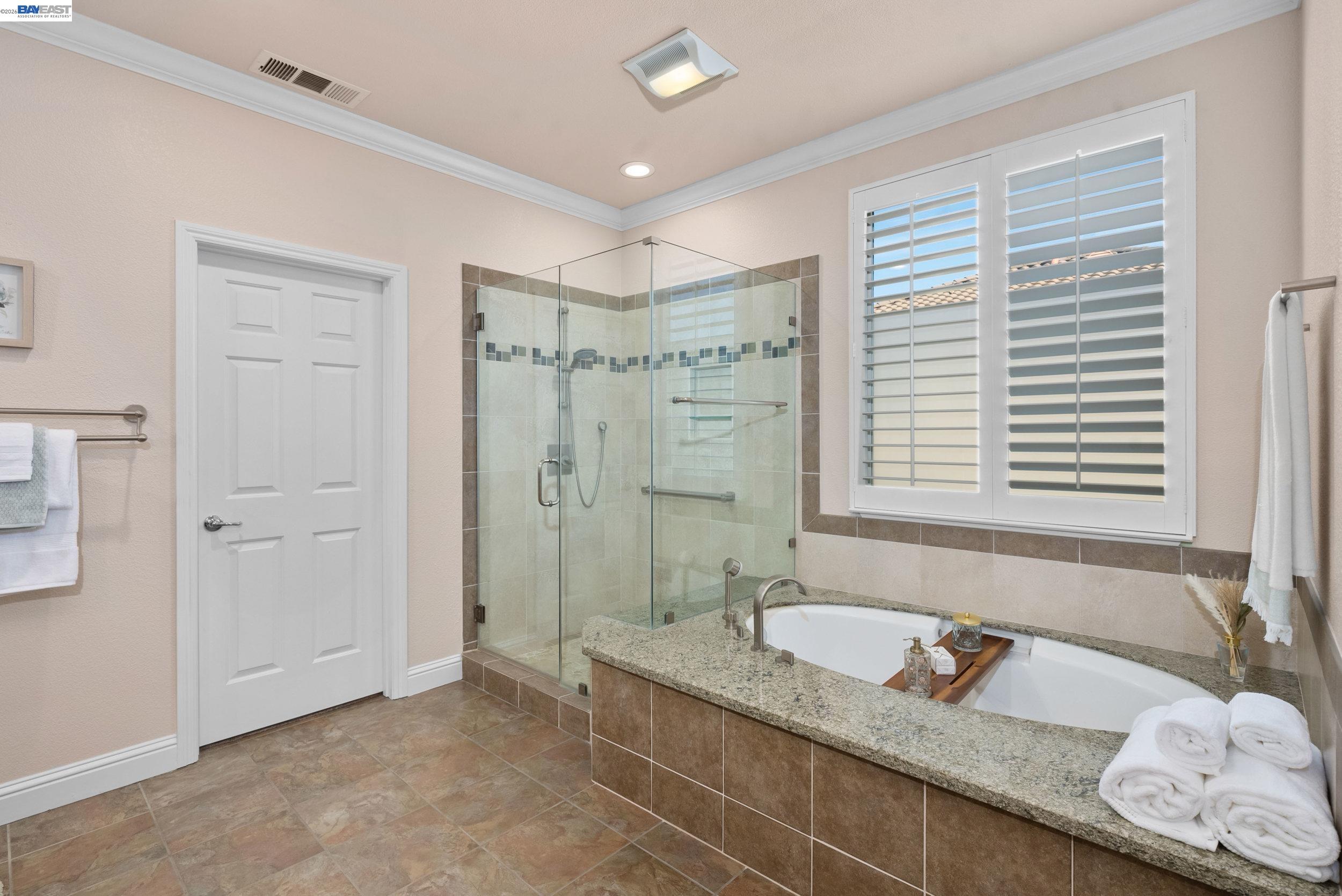 4717 Chestnut Court Dublin, CA 94568 - Photo 33 of 60 a bathroom with a granite countertop sink and a bathtub