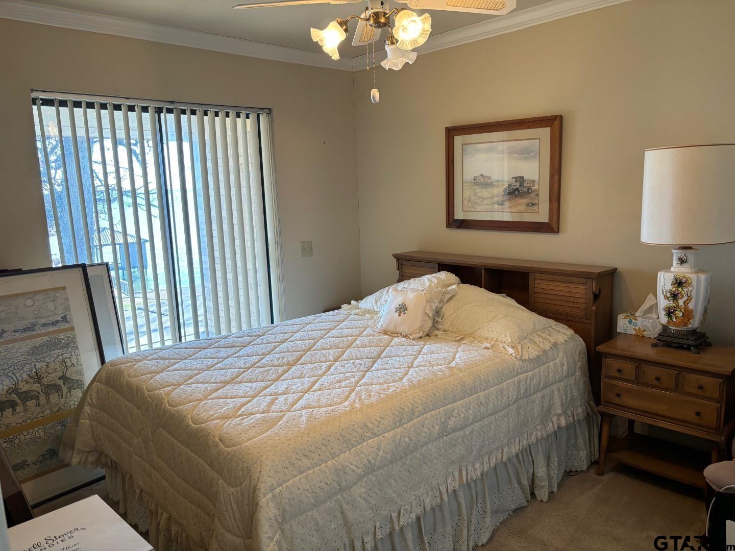 17656 Old River Road Flint, TX 75762 - Photo 17 of 20 a bedroom with a bed and a lamp on dresser