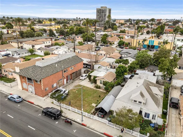 an aerial view of residential houses with city view