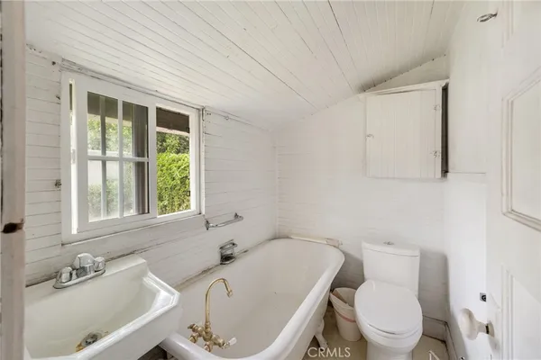 a bedroom with a bed next to a window with the outer view