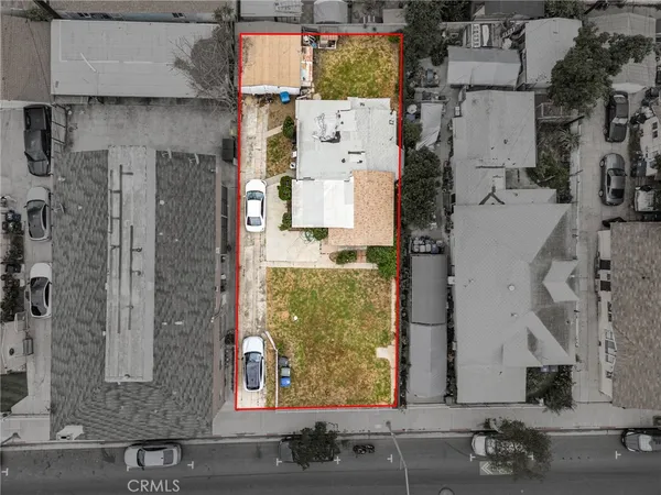 an aerial view of residential house with parking