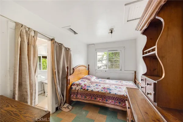 a bedroom with a bed next to a window with the outer view