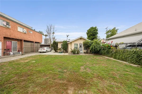 a front view of a house with a yard and fountain