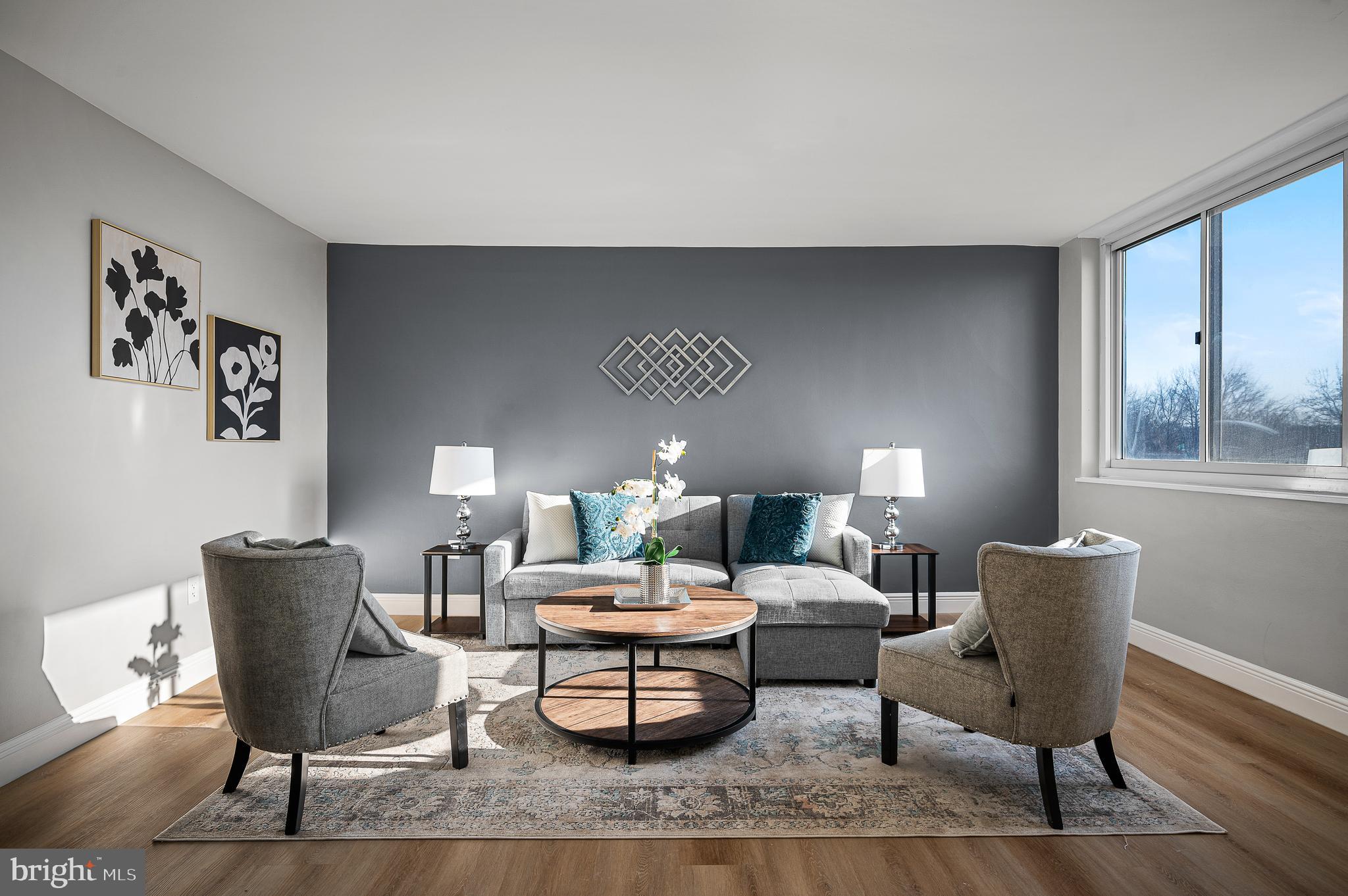 a living room with furniture and a lamp