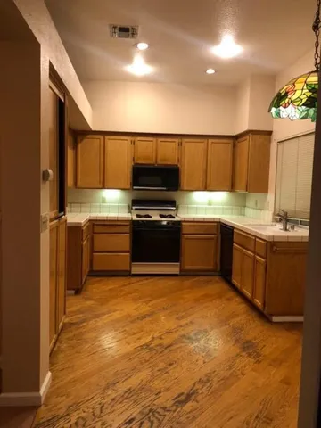 a bathroom with a double vanity sink a mirror and a bathtub
