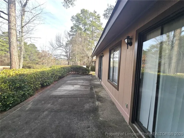 a view of a pathway of a house with backyard and garden