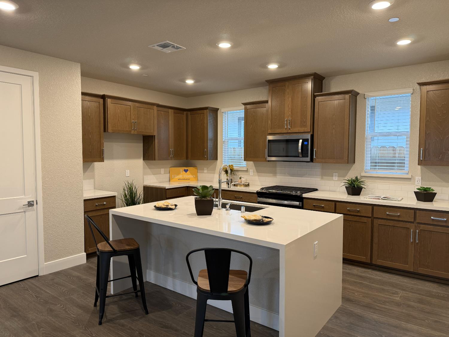 11501 Lagarto Way Rancho Cordova, CA 95742 - Photo 2 of 10 a kitchen with a sink a stove a refrigerator and chairs