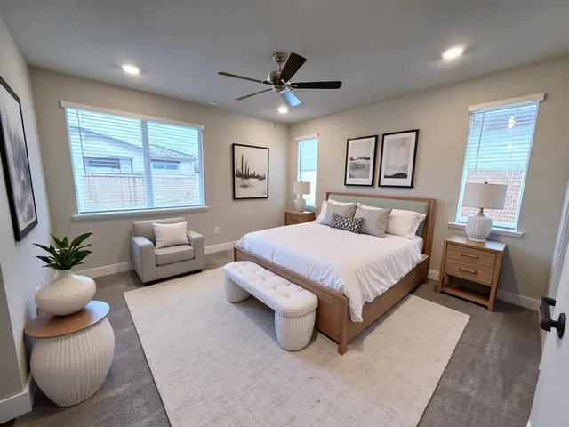 a bedroom with a bed couches and window