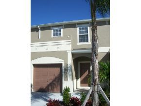 2785 Reston Street, Unit 104 Melbourne, FL 32935 - Photo 3 of 12 a front view of a house with plants