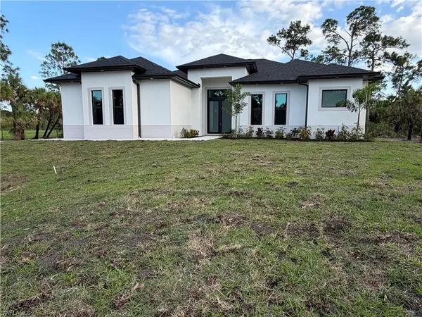 a house with lots of trees in the background