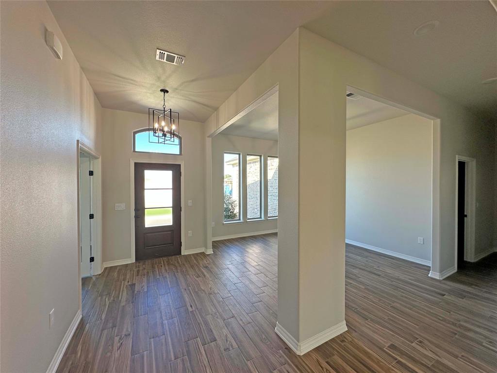 133 Lasso Loop Lorena, TX 76655 - Photo 10 of 22 wooden floor in an empty room with a window
