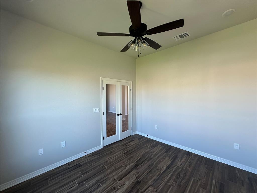133 Lasso Loop Lorena, TX 76655 - Photo 11 of 22 a view of a room with wooden floor and white walls