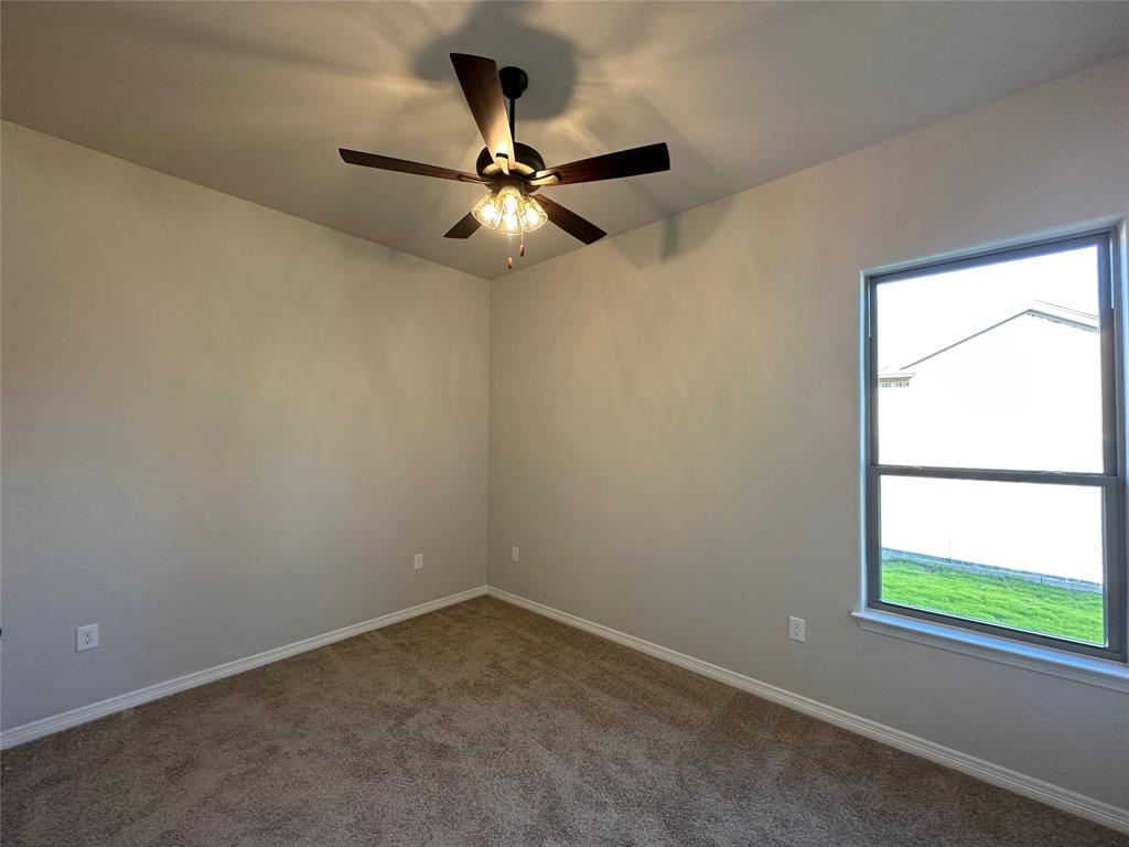 133 Lasso Loop Lorena, TX 76655 - Photo 18 of 22 an empty room with a window and a fan