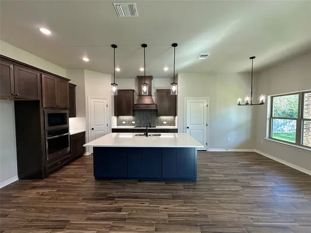 a view of an empty room with a fireplace and a window