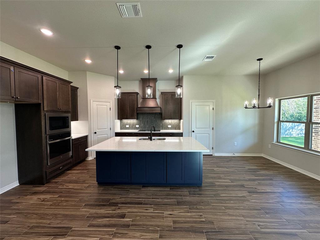 133 Lasso Loop Lorena, TX 76655 - Photo 5 of 22 a large kitchen with stainless steel appliances kitchen island granite countertop a large counter top a stove and a refrigerator
