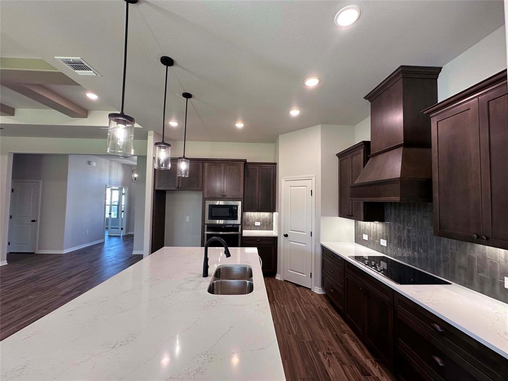 133 Lasso Loop Lorena, TX 76655 - Photo 6 of 22 a large kitchen with stainless steel appliances kitchen island a large counter top a stove a refrigerator cabinets a sink and a couch