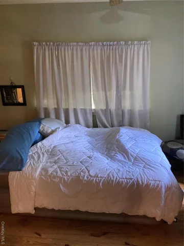 a large bed sitting in a bedroom next to a window
