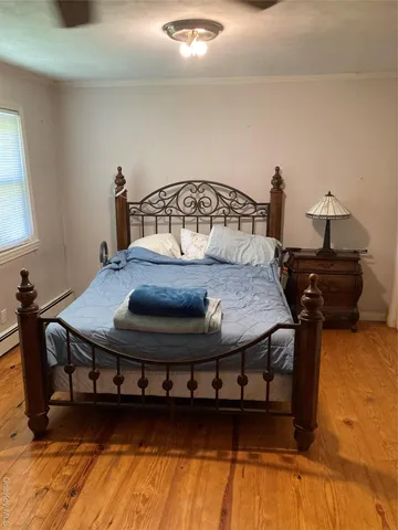 a bed sitting in a bedroom next to a window