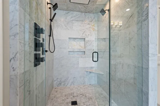 a spacious bathroom with a granite countertop double vanity sink a mirror a vanity and a bathtub