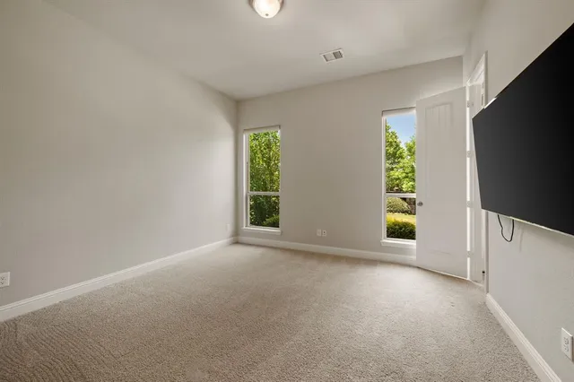 a view of an empty room with a tv