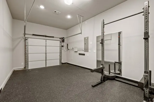 a view of a livingroom with a fireplace a ceiling fan and a large window