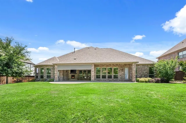 an aerial view of a house with a garden and swimming pool