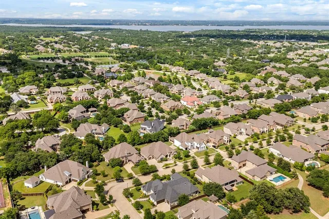 a view of a house with a yard and potted plants