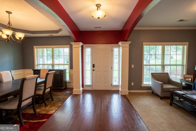 a view of a livingroom with furniture window and wooden floor