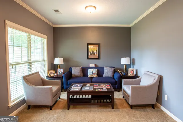 a living room with furniture and a large window