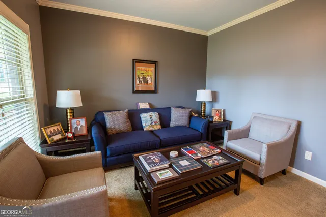 a living room with furniture a lamp and a window