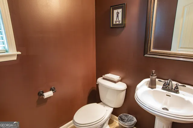 a white toilet sitting next to a bathroom sink