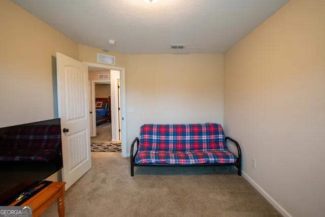 a reading room with furniture and a window