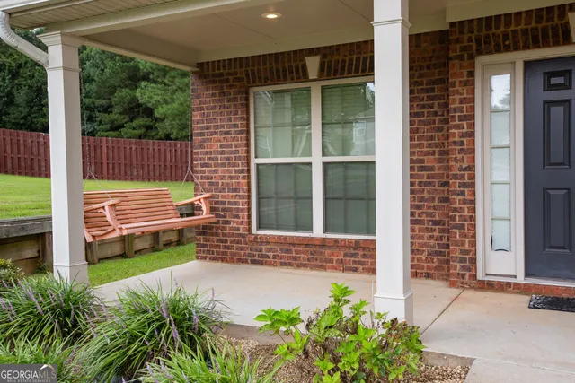 a view of front door of house with potted plants