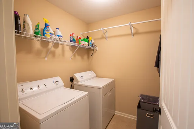 a bedroom with a bed and a flat tv screen on a dresser
