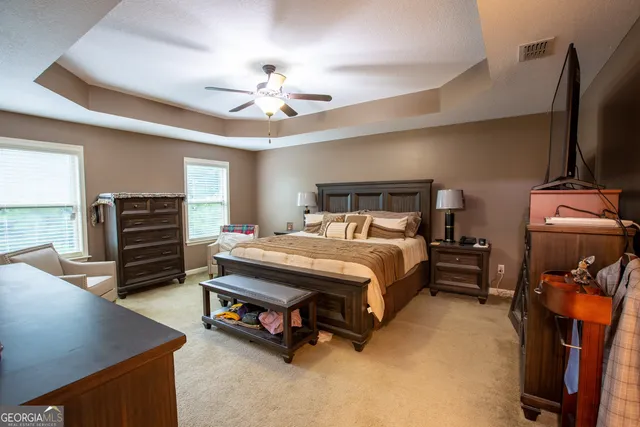 a bedroom with a bed and ceiling fan