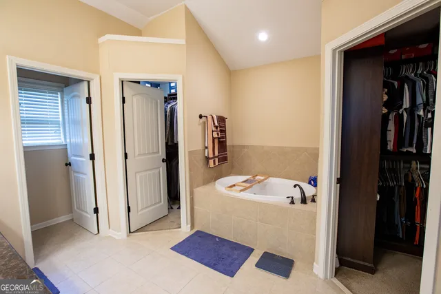 a bathroom with a sink double vanity granite and a mirror