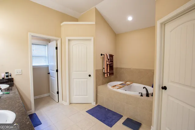 a bathroom with a granite countertop toilet and a sink