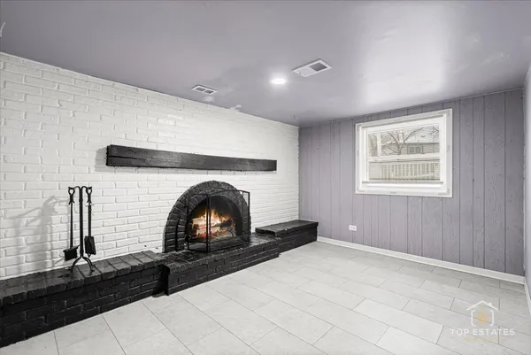 a room with window and a fireplace