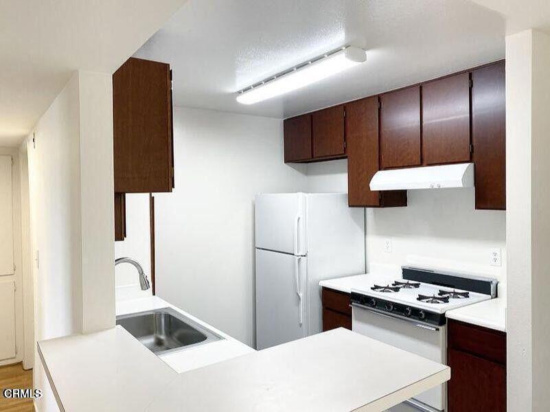4018 Camero Avenue, Unit 2 Los Angeles, CA 90027 - Photo 1 of 14 a kitchen with a refrigerator and a sink