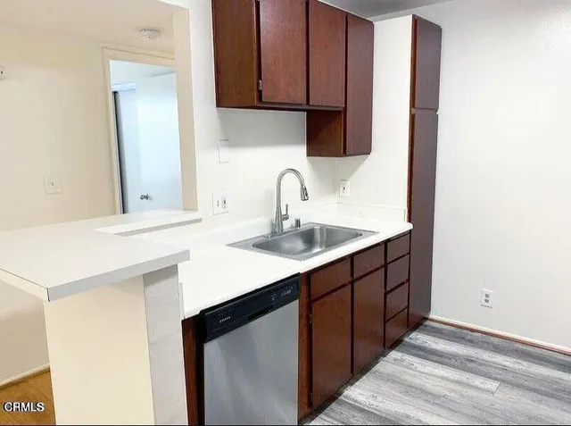 a kitchen with a sink cabinets and a window