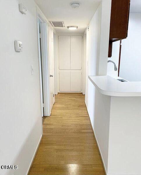4018 Camero Avenue, Unit 2 Los Angeles, CA 90027 - Photo 4 of 14 a view of a hallway with wooden floor and a bathroom
