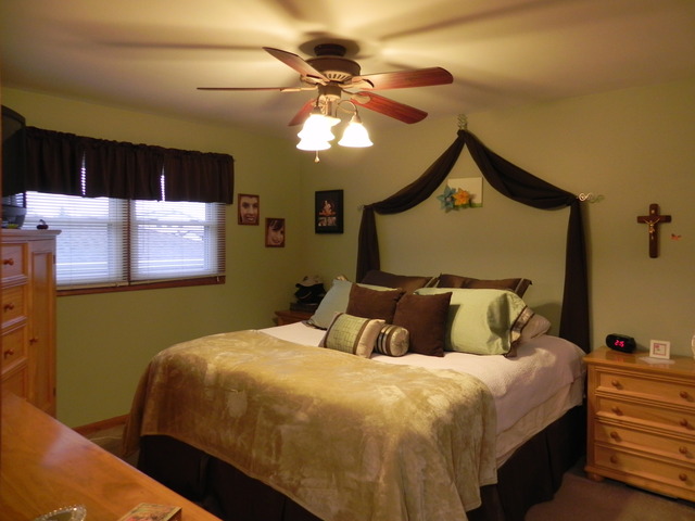 1034 Southgate Road New Lenox, IL 60451 - Photo 16 of 21 a bedroom with a bed and a chandelier