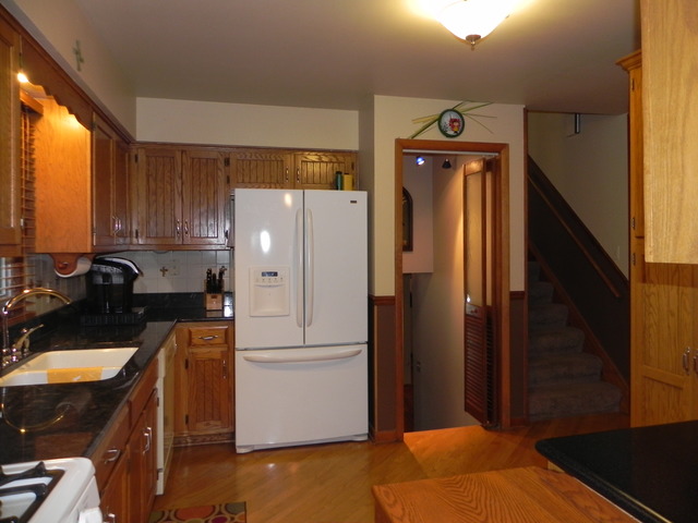 1034 Southgate Road New Lenox, IL 60451 - Photo 4 of 21 a kitchen with a refrigerator and a stove top oven