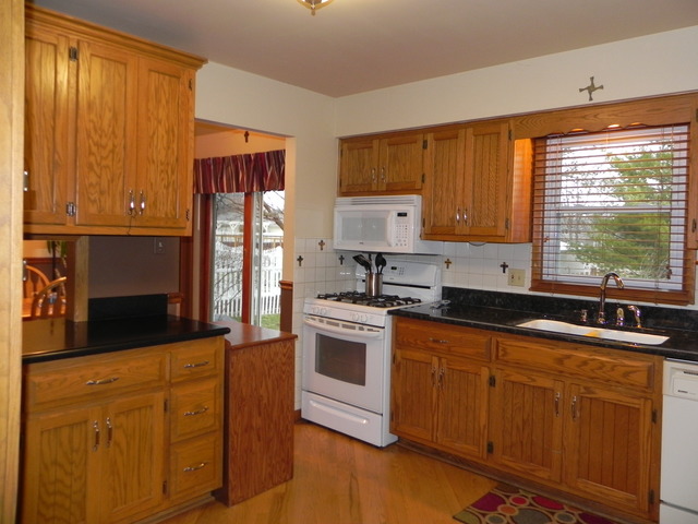 1034 Southgate Road New Lenox, IL 60451 - Photo 5 of 21 a kitchen with stainless steel appliances granite countertop a stove a sink and a microwave