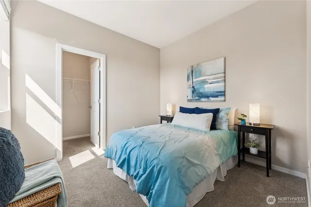 a bedroom with a bed and a painting on the wall