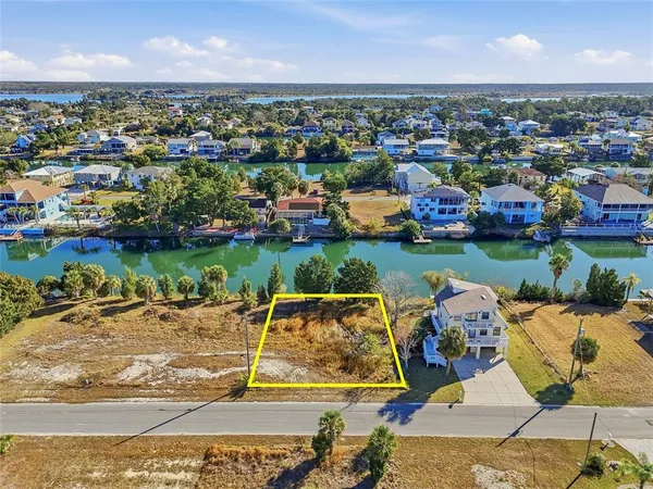 an aerial view of a house with garden space and lake view