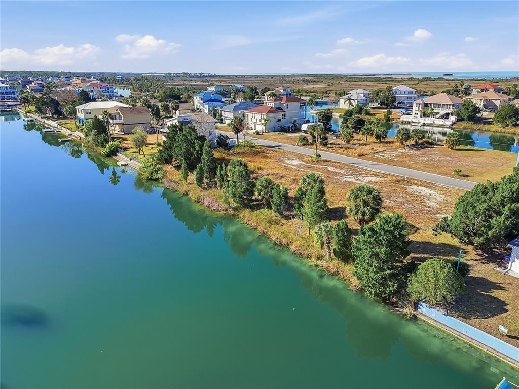 3302 Gardenia Drive Hernando Beach, FL 34607 - Photo 2 of 14 an aerial view of residential houses with outdoor space and trees