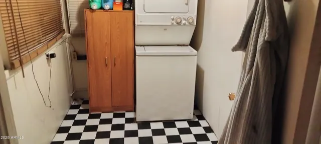 a view of a storage & utility room with a washing machine