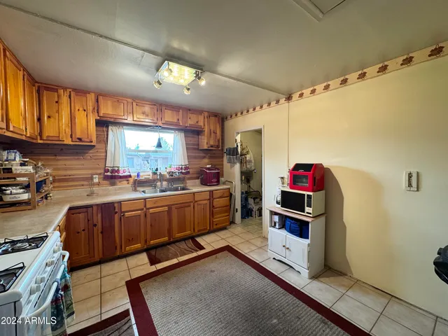 a kitchen with granite countertop a sink cabinets and window