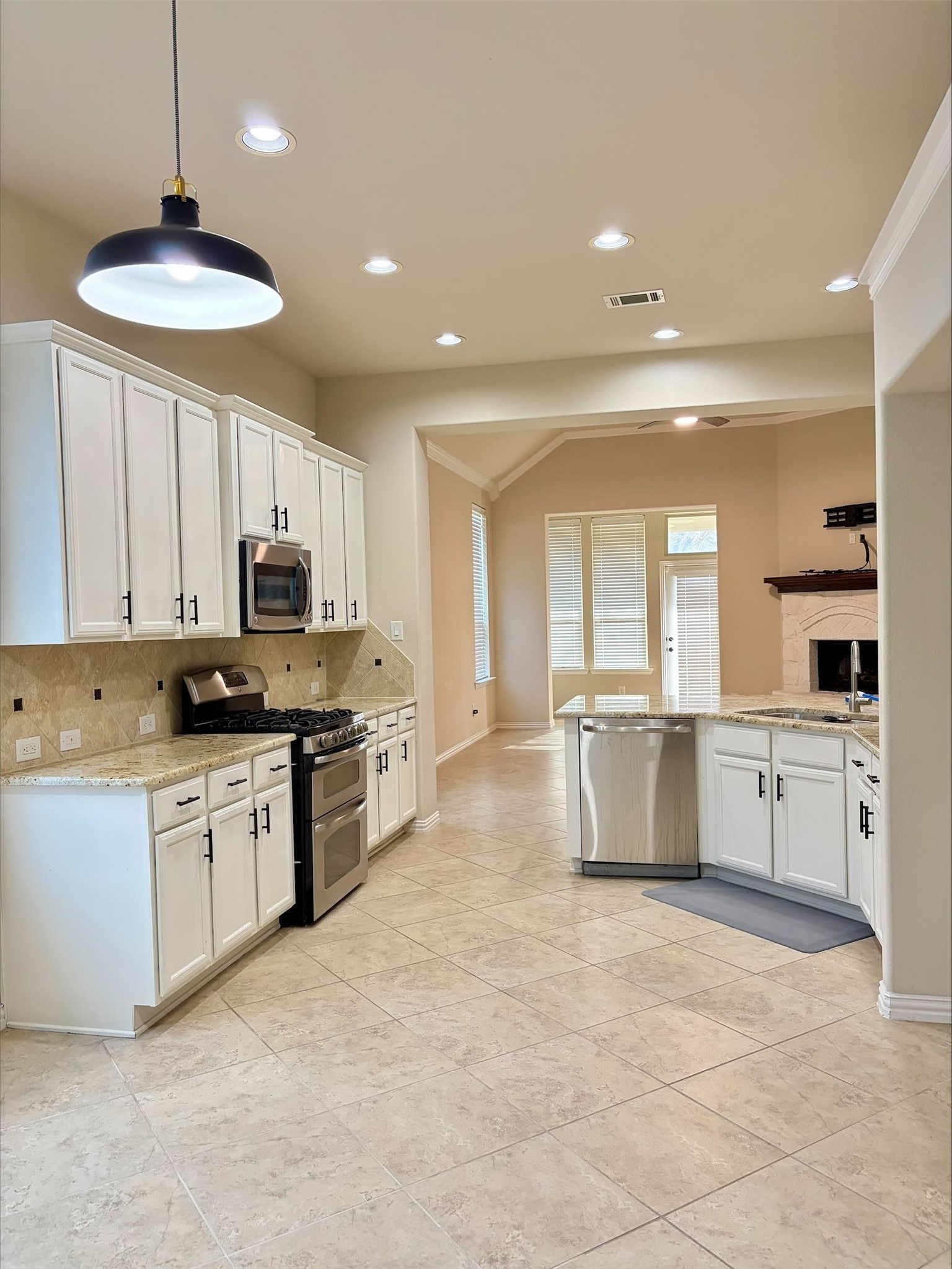 3042 Currant Drive Manvel, TX 77578 - Photo 5 of 12 a large kitchen with kitchen island a sink stainless steel appliances and cabinets